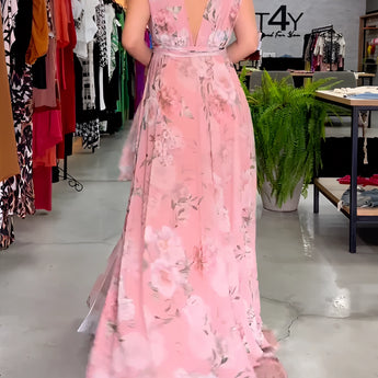 Elegant pink floral sleeveless V-neck maxi dress featuring a fitted waist, perfect for spring weddings.