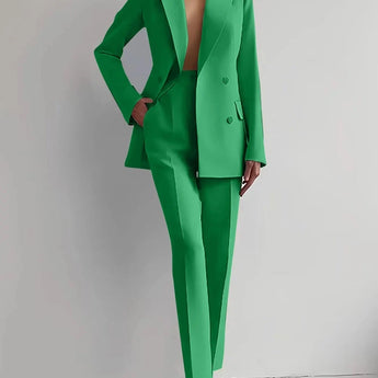 Elegant green women's suit featuring a tailored blazer and trouser set in size 2XL, showcasing the outfit's fit on the shoulders, arms, and waist while standing.