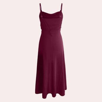 Elegant plus size green maxi dress featuring a cowl neck and sleeveless design, highlighting formal fashion elements with a stylish waist and flowing silhouette.
