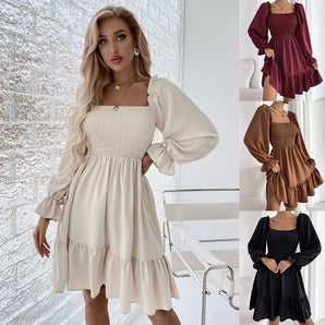 Elegant puff sleeve dress with a ruffled hemline and tiered skirt, featuring a black and white color scheme, showcasing shoulder and neck details.