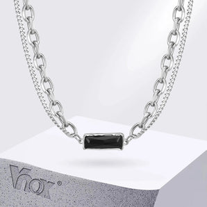 Elegant silver chain necklace with black stone pendant on display.