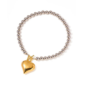 Elegant Silver and Gold Heart Charm Bracelet featuring intertwined heart charms on a delicate chain, perfect romantic jewelry gift.