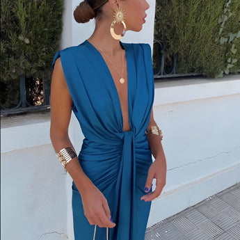 Elegant sleeveless purple gown with a draped neck and high slit, showcasing a stylish and sophisticated design suitable for formal occasions.