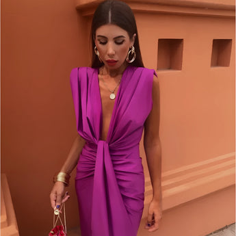 Elegant sleeveless purple gown featuring a draped neck and a high slit design, showcasing a sophisticated fashion style.