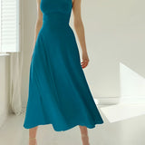 Elegant teal midi dress with a sleeveless fit and flare design, perfect for formal events, displayed on a mannequin near a window.