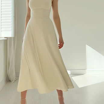Elegant teal sleeveless midi dress in fit and flare style, featuring a formal design suitable for weddings or bridal parties.