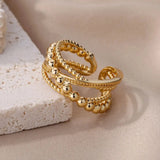 Elegant textured gold bead ring with intricate design, premium designer jewelry, circular gold band, fashion accessory.