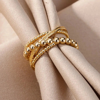 Elegant textured gold bead ring on a finger, showcasing premium designer jewelry.