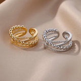 A hand wearing an elegant textured gold bead ring on the finger, showcasing the premium designer jewelry with a close-up view of the intricate design and natural material.