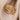 Elegant textured gold bead ring displayed on a model's finger, highlighting premium designer craftsmanship.
