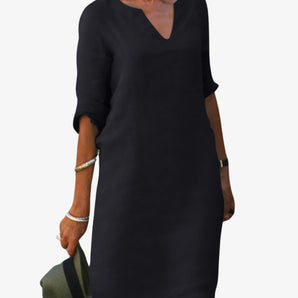 Elegant V-neck black dress with 3/4 sleeves and knee-length hem, suitable for business casual settings.