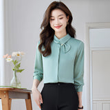 Elegant white bow tie blouse in turquoise, featuring long sleeves and a chic design suitable for office or formal events, displayed in size 2XL.