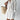 Elegant white lace blouse with sheer panels and intricate embroidery, featuring long sleeves, a high neck, and a fitted waist, shown in size Large.