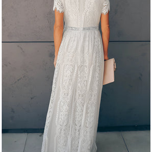 Elegant white lace maxi dress with vintage-inspired design, featuring intricate lace detailing, fitted waist, and flowing skirt, suitable for formal occasions or bridal events.