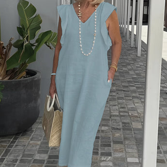 Elegant white linen V-neck summer dress paired with a pearl necklace, showcased on a model with stylish sunglasses and an updo hairstyle. The dress is in the Azzurro color variant and size 3XL.