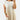 Elegant white midi pleated dress with short sleeves and a defined waist, showcasing a casual chic style suitable for summer.