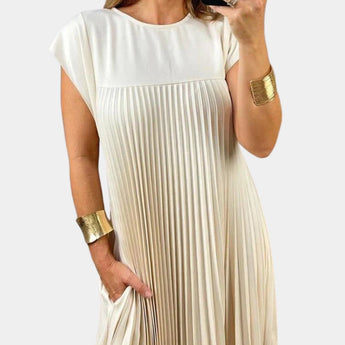 Elegant white midi pleated dress with short sleeves and a defined waist, showcasing a casual chic style suitable for summer.