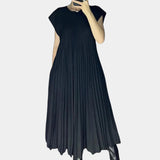 Elegant white midi pleated dress with flowing design, featuring a fitted bodice, short sleeves, and a crew neckline, perfect for a casual chic summer look.