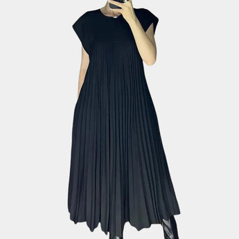 Elegant white midi pleated dress with flowing design, featuring a fitted bodice, short sleeves, and a crew neckline, perfect for a casual chic summer look.