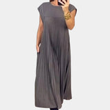 Elegant gray midi pleated dress featuring short sleeves and a defined waistline, suitable for casual summer outings.