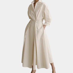 Elegant white midi trench coat with belted waist, 3/4 sleeves, and lightweight fabric, featuring a wrap style and collar.