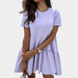 Elegant white ruffle hem mini dress in a vibrant purple color, designed for women, shown in extra-large size. The dress features a casual summer style with short sleeves and a fitted silhouette, highlighting the ruffle hem detail.