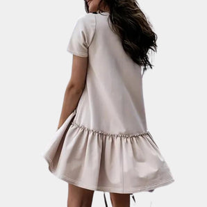 Elegant white ruffle hem mini dress with short sleeves, perfect for summer casual wear, modeled by a woman showcasing the dress's fitted waist and flowing knee-length skirt.
