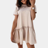 Elegant white ruffle hem mini dress for women, featuring a flowy silhouette with a casual summer style. The dress has a khaki tint and is available in XL size, showcasing a one-piece design with short sleeves and a round neckline.
