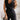 Woman wearing an elegant white sleeveless V-neck belted formal jumpsuit, accessorized with a watch.