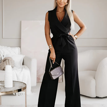 Elegant white sleeveless V-neck belted formal jumpsuit for women, showcasing a stylish and sophisticated design, modelled by a woman with black hair.