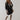 Elegant women's oversized beige wool coat with a high-collar design, displayed in a black color variant, size 2XL. The coat features a classic tartan pattern and is modeled by a person showcasing the shoulder and neck areas, emphasizing the coat's stylish and practical outerwear qualities for winter.