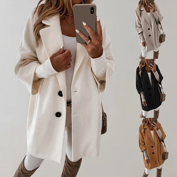 Elegant women's beige oversized wool coat with a high collar, showcasing the shoulder and arm design, ideal for winter outerwear.