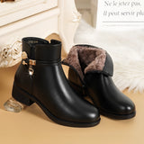 Elegant women's black leather ankle boots featuring a chic winter style, showcasing a sleek design with a durable synthetic rubber sole and stylish fashion elements.