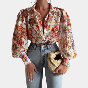 Elegant women's orange blouse featuring abstract design with sheer bell sleeves, showcasing a fashionable office chic style.
