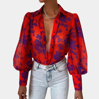 Elegant women's blouse with a blue abstract pattern featuring sheer bell sleeves, a sophisticated collar, and tailored waist, designed for an office chic look.