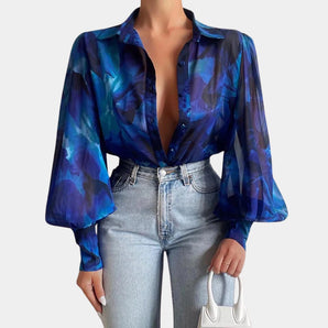 Elegant Women's Blue Abstract Sheer Bell Sleeve Blouse - Office Chic in XL, featuring sheer bell sleeves and an abstract design, modeled by a fashion model.