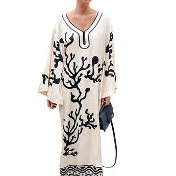 Elegant women's botanical print maxi robe displayed in a luxurious spa setting, showcasing the robe's flowing design and vibrant botanical patterns.