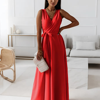 Elegant women's formal pink maxi dress with a V-neckline, styled as a one-piece garment. The dress is designed for bridesmaid and evening occasions, featuring a fitted waist and flowing thigh-length skirt. The model with black hair showcases the gown's fashion design and formal wear appeal.
