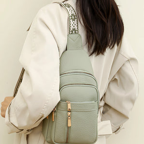 Elegant women's pale green leather mini backpack being worn, showcasing its stylish and compact design suitable for daywear. The backpack is highlighted against a backdrop including elements like sleeves and waist, suggesting a fashionable and modern look.
