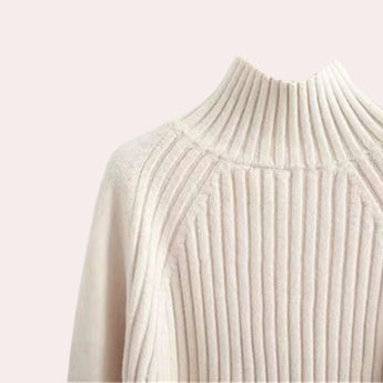 Elegant cream-colored ribbed mock neck sweater for women with long sleeves and a turtleneck design.