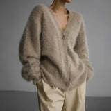 Elegant women's oversized sweater in soft beige fur, featuring long sleeves and a cozy wrap-around design ideal for winter fashion. The plush texture and woolen appearance make it perfect for keeping warm in style.