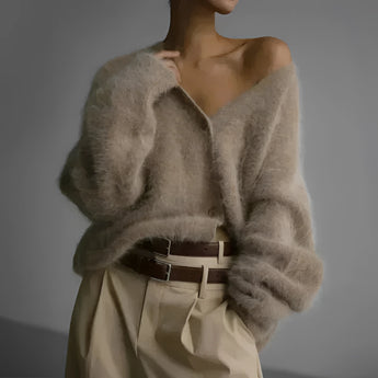 Elegant women's soft fur oversized sweater in a plush grey fabric, featuring a cozy design that highlights the shoulder and neck areas with long sleeves, perfect for winter fashion.