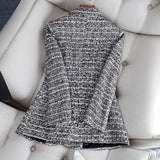 Elegant women's tweed blazer in a chic monochrome pattern, featuring a stylish shoulder design and suitable for formal office wear.