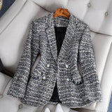 Elegant women's tweed blazer in chic monochrome, featuring a formal office wear design in black, suitable for size 3XL. The blazer exhibits a sophisticated collar and full-length sleeves, crafted from high-quality textile, with a tailored fit reminiscent of a suit jacket style.