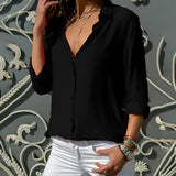 Elegant yellow silk blouse for women with a high-neck, pleated back, and rolled sleeves.