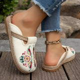 Embroidered floral espadrilles in beige and pink tones, featuring a boho chic design with slip-on style, set against a white background.