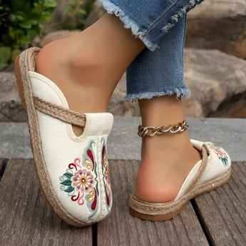Embroidered floral espadrilles in beige and pink tones, featuring a boho chic design with slip-on style, set against a white background.