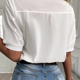 A white floral lace blouse with short sleeves, featuring intricate embroidery and eyelet details.
