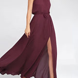 Emerald green halter neck chiffon maxi dress with a fitted waist, suitable for bridesmaid or gala events, displayed in chestnut brown, size 2XL.