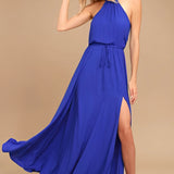 Emerald green halter neck maxi dress made from chiffon, designed for bridesmaid or gala events, featuring a fitted waist and flowing silhouette.